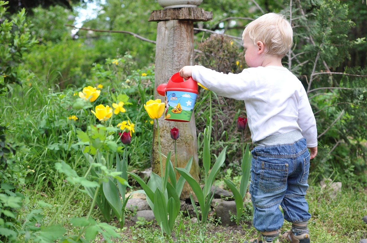 a kid watering plants